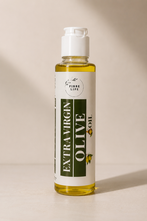 A bottle of Fibre Life Extra Virgin Olive Oil with a white cap and a white label featuring dark green text, set against a warm beige background with soft shadows.